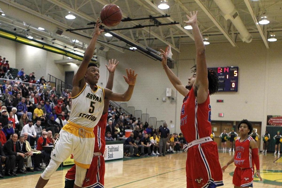 Bryan Station's Eric Boone shoots against Scott County's Michael Moreno at Bryan Station gym in Lexington, Ky., Monday, January 22, 2018.