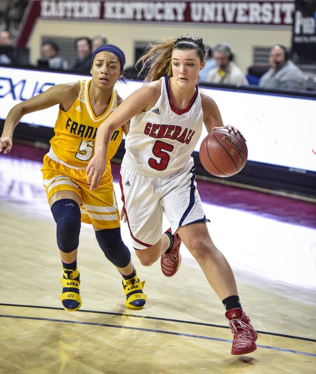 Lafayette's Caroline Bennett (5) drives around Franklin County's Princess Stewart (5), during the girls 11th Region Tournament finals, Saturday, March 4, 2017, at EKU's McBrayer Arena in Richmond.