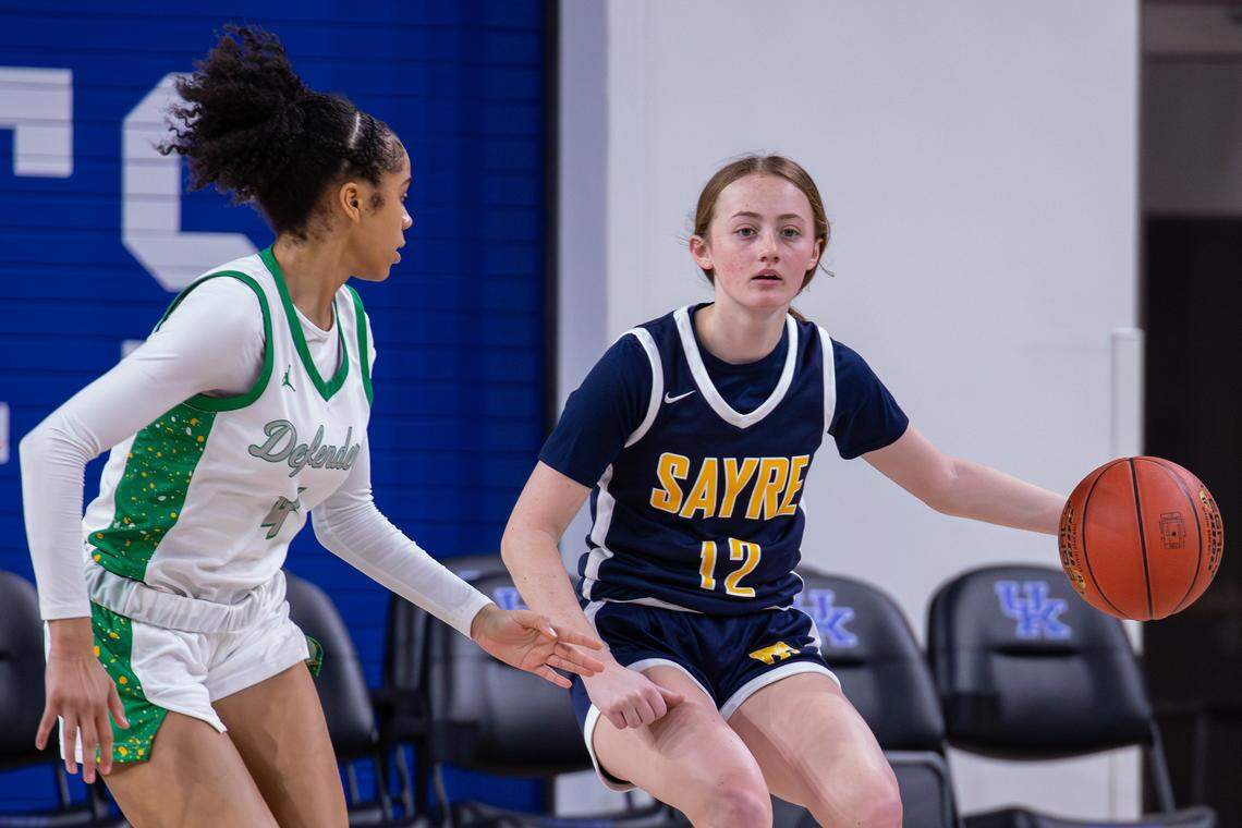 Sayre Lady Spartans Kathryn Kinder is guarded by Bryan Station Defenders Jakai Wilkerson during the girls and boys doubleheader high school basketball game at Historic Memorial Coliseum on Jan. 23, 2026, in Lexington, Ky.