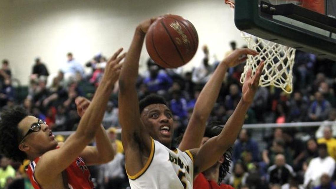 Bryan Station's Eric Boone battles for the offensive board against Scott County's Lorenzo Williams, left, at Bryan Station gym in Lexington, Ky., Monday, January 22, 2018.
