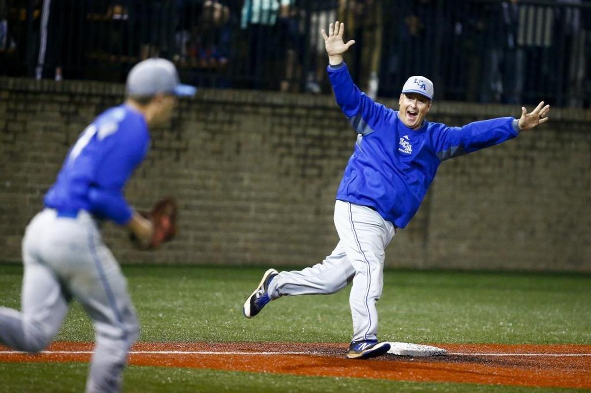 Lexington Christian assistant coach Jeff Smith celebrates after their 6-4 victory over Lexington Catholic in the 43rd District baseball tournament semifinal at Lexington Catholic High School in Lexington, Ky., Wednesday, May 24, 2017.