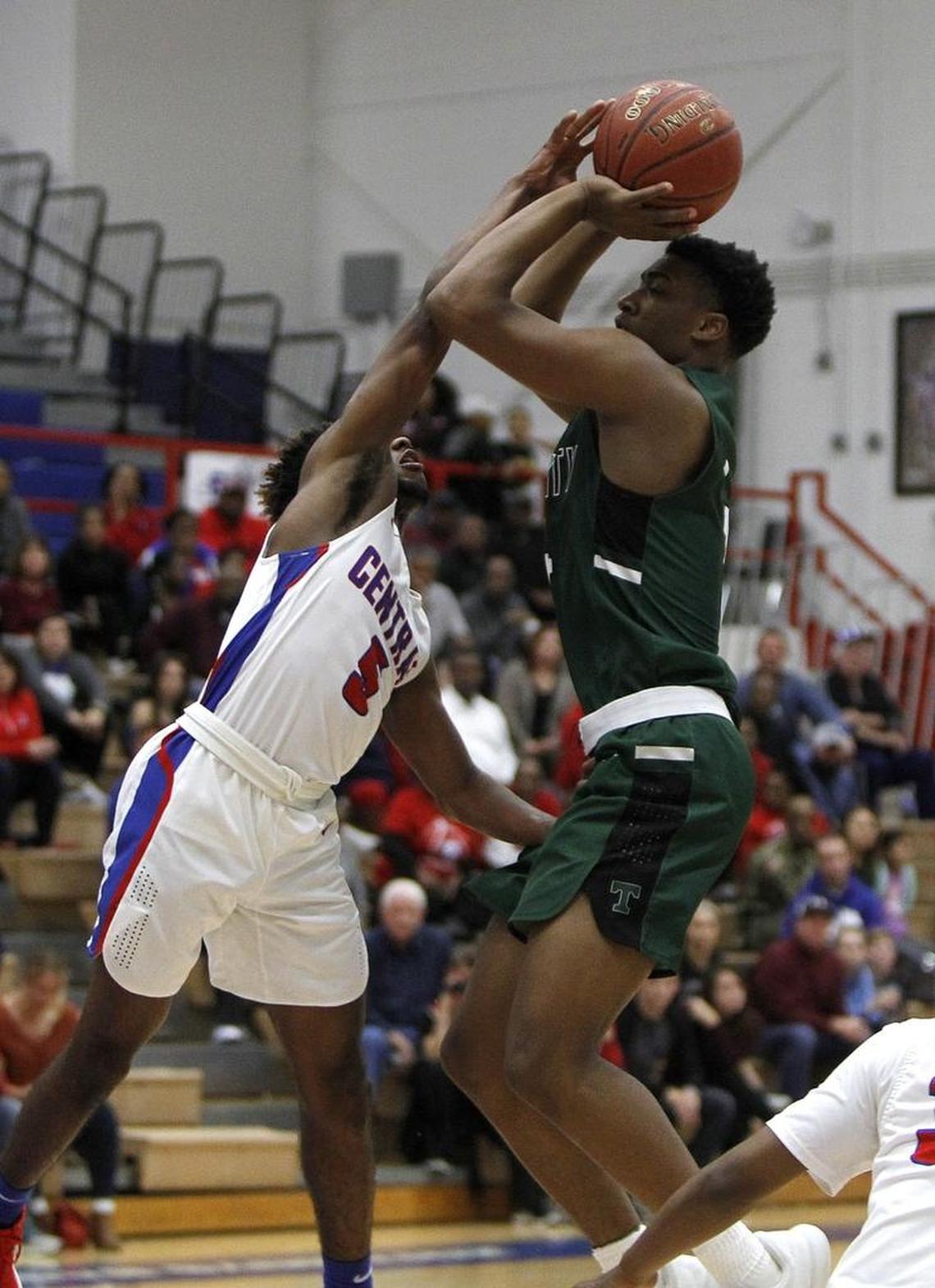 Madison Central's Isaiah Minter blocks the shot by Trinity's Jay Scrubb at Madison Central gymnasium in Richmond, Ky., Friday, January 26, 2018.