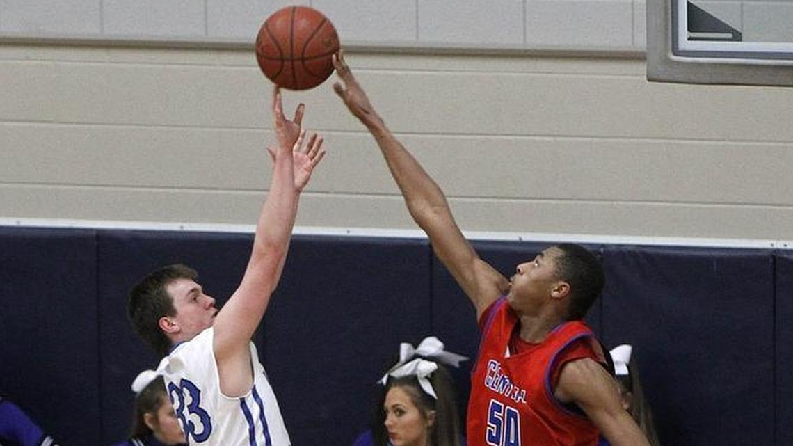 Madison Central's Isaiah Cozart blocks the shot by Lexington Catholic's Ben Johnson, left, Tuesday at Lexington Catholic.