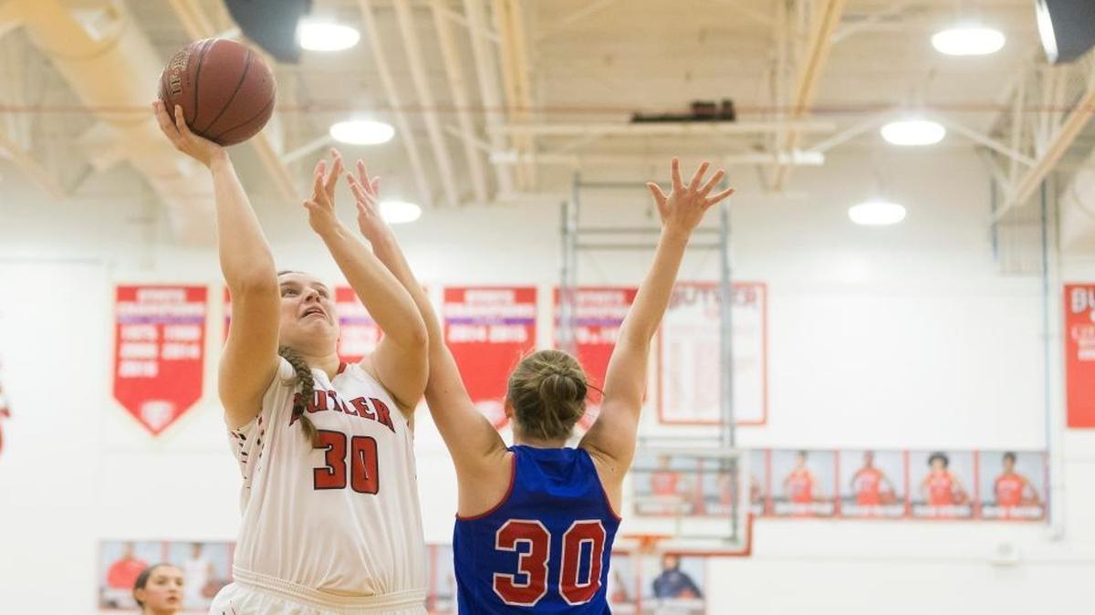 Butler center Molly Lockhart (30) shot the ball under pressure from Mercer County forward Emma Souder (30).
