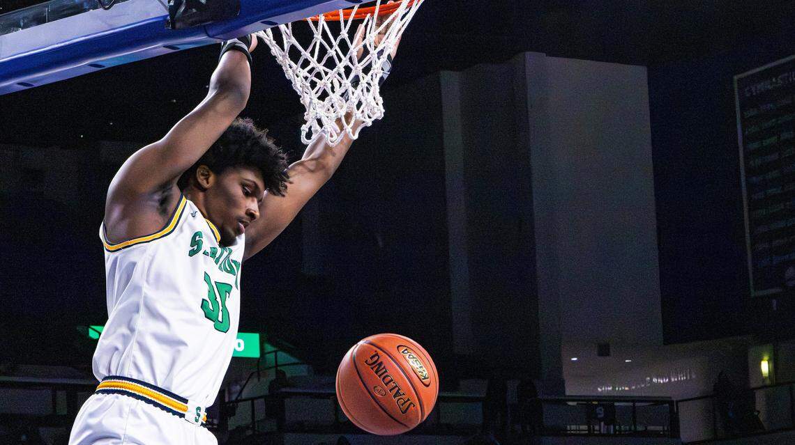 Bryan Station Defenders Taeshawn Adams two-point slam-dunk during the girls and boys doubleheader high school basketball game at Historic Memorial Coliseum on Jan. 23, 2026, in Lexington, Ky.