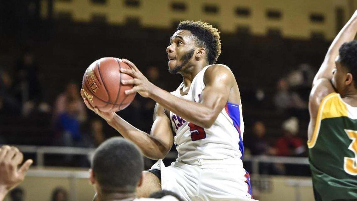Madison Central's Isaiah Minter (5) drives against Bryan Station's Myles Morones (23), during the first round of the 11th Region tournament, Wednesday night, February 28, 2018, at EKU's McBrayer Arena in Richmond.