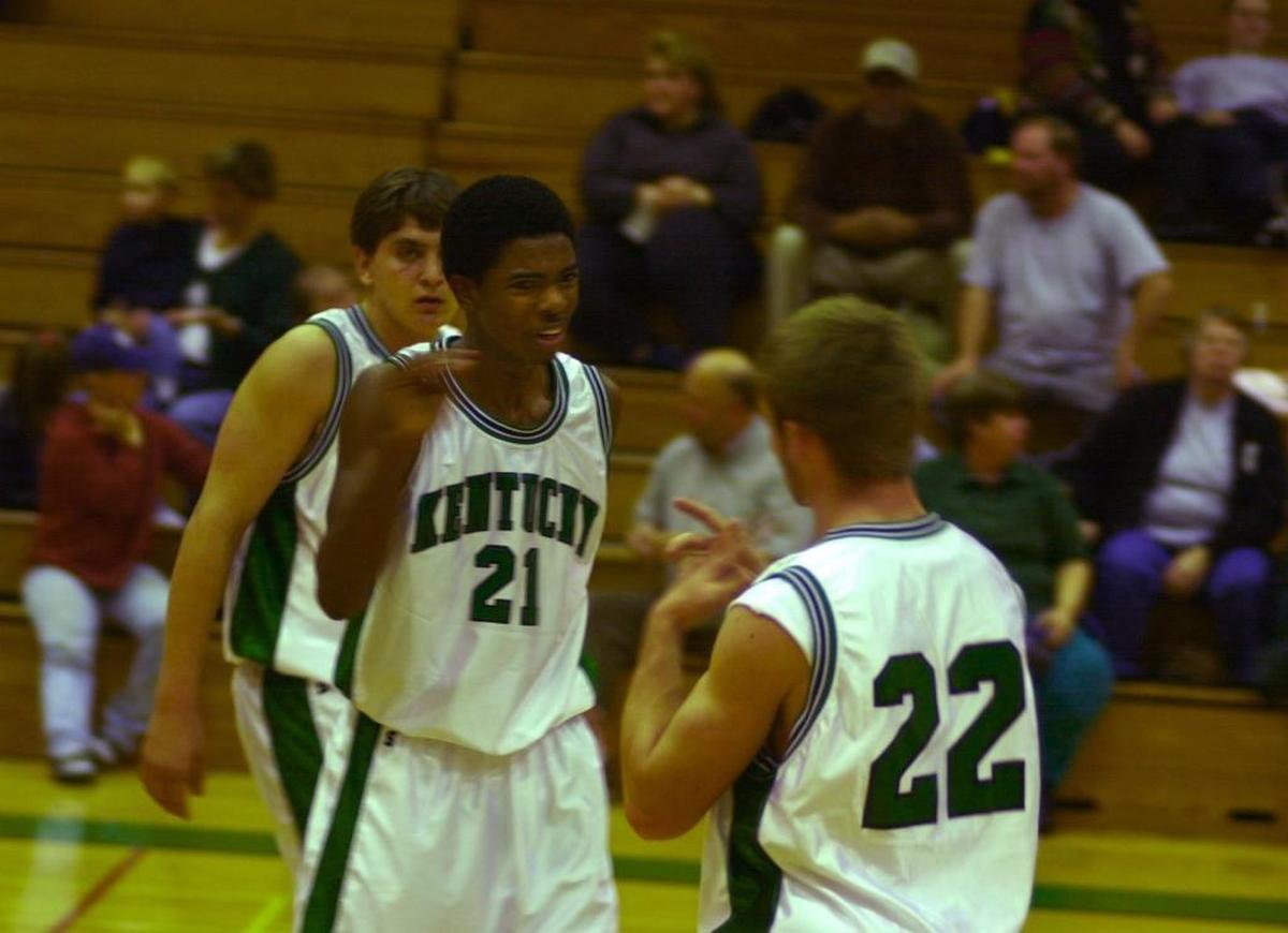 File photo: Kentucky School for the Deaf basketball players Sekoe White (21) and Austin Bradford (22) communicated via sign language as the Kentucky School for the Deaf played against the Tennessee School for the Deaf in Danville, Ky., on Dec. 14, 2000.
