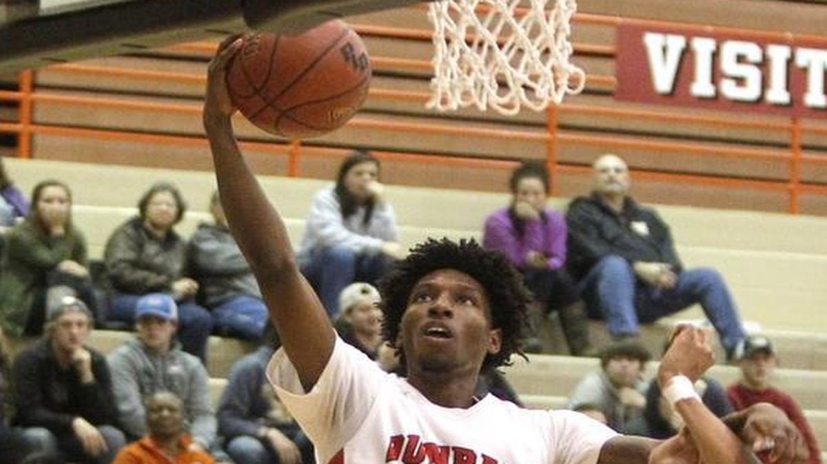 Paul Laurence Dunbar's Taveion Hollingsworth shoots against Woodford Co. in the S. T. Roach Gymnasium in Lexington, Ky., Monday, November 28, 2016.