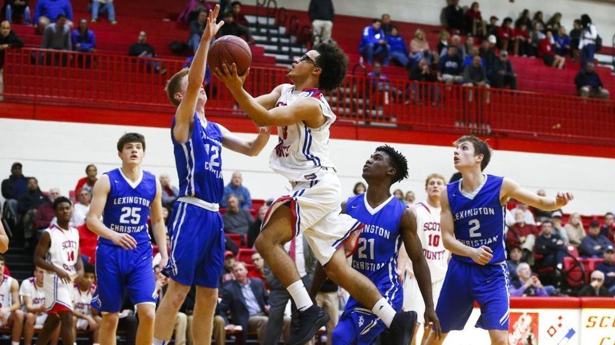 Scott County’s Lorenzo Williams (33) went to the hoop against Lexington Christian’s Will Hacker (12) and Isaiah Hunt (21) during their game on Dec. 7, 2017. Scott County won 68-59.