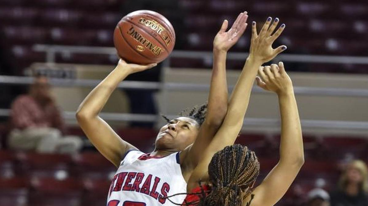 Lafayette's Tekiya Garr-Carter (15) shoots past Scott County's Maaliya Owens (11), during the girls’ 11th Region Tournament semifinals, Friday night, March 3, 2017, at EKU's McBrayer Arena in Richmond.