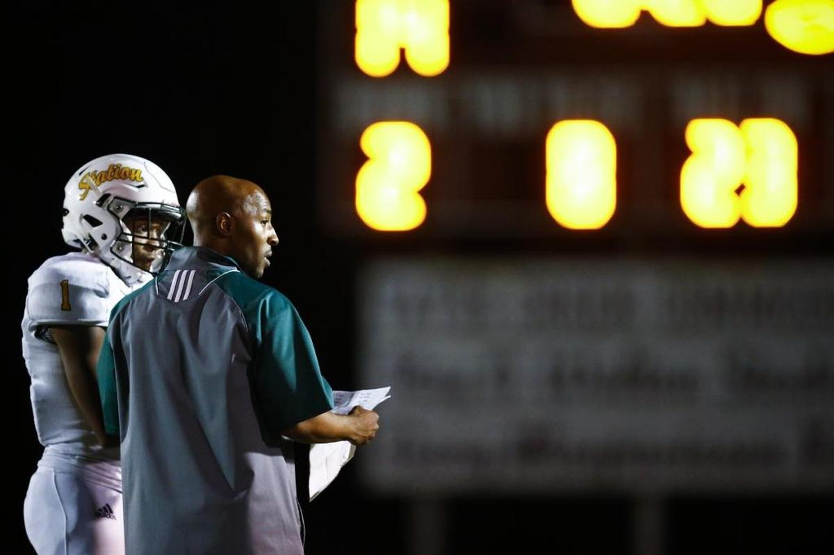 Bryan Station head coach Frank Parks spoke with Jalen Burbage (1) during a game in the Adidas Kickoff Classic at Tates Creek High School last August.