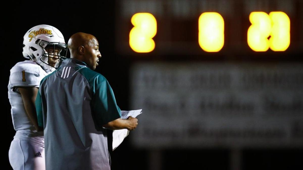 Bryan Station head coach Frank Parks spoke with Jalen Burbage (1) during a game in the Adidas Kickoff Classic at Tates Creek High School last August.