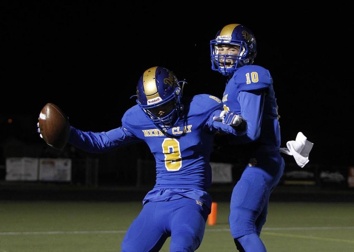Henry Clay's Michael McMullen, left, celebrates with quarterback D. J. Van Horn after the pair combined for a touchdown against Cooper at Dr. Robert Feld Stadium in Lexington, Ky., Friday, October 27, 2017.