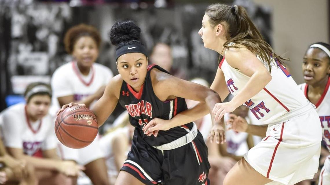 Dunbar's Mashayla Cecil (23) drives past Scott County's Peyton Riddle (22), during the semi finals of the 11th Region tournament, Friday night, March 2, 2018, at EKU's McBrayer Arena in Richmond.