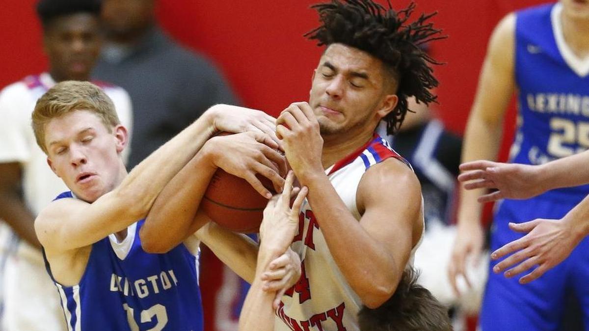 Lexington Christian's Will Hacker (12) Scott County's Michael Moreno (24) and Lexington Christian's Pearce Dalton (2) battle for the ball with during their game at Scott County High School in Georgetown, Ky., Thursday, Dec. 7, 2017. Scott County beat Lexington Christian 68-59.