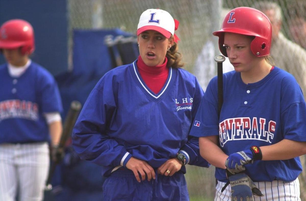 Lafayette Coach Allison Denton, left, instructs Sarah Riffe, right, before Riffe's turn at bat during a softball game versus Paul Laurence Dunbat at Shillito Park in Lexington, Ky., on April 13, 2000.