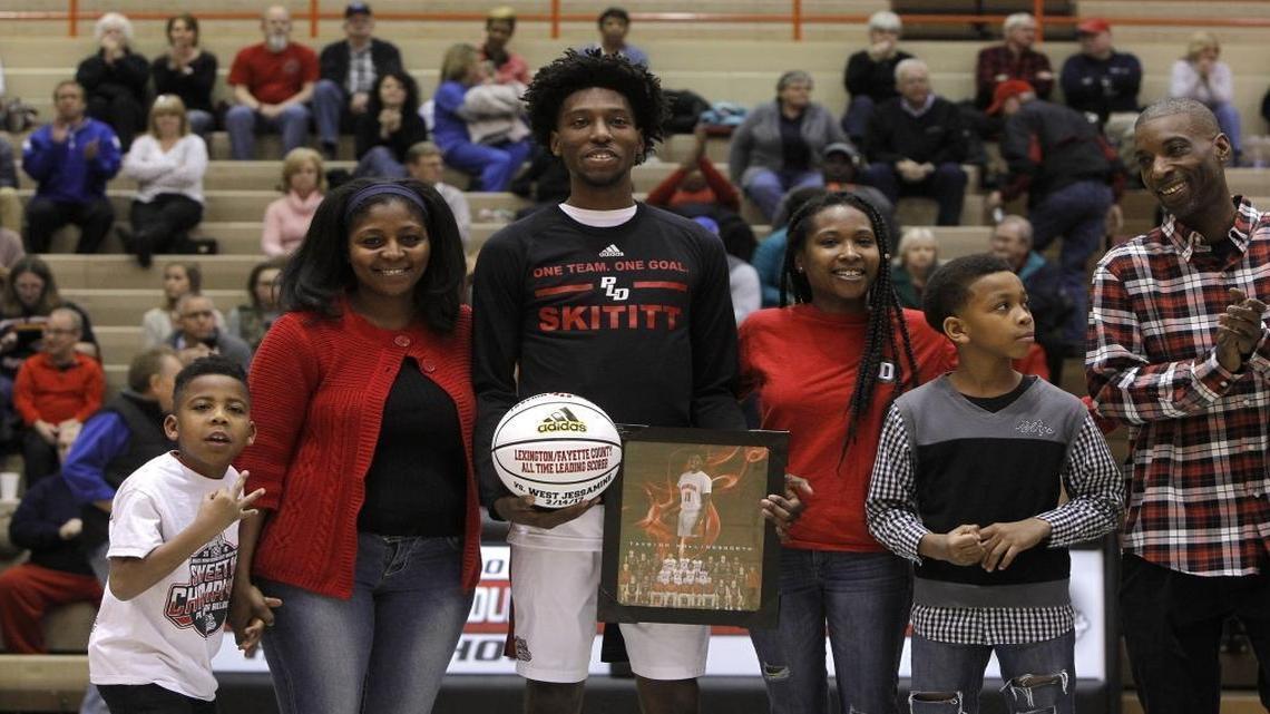 Paul Laurence Dunbar's Taveion Hollingsworth was presented a commemorative basketball as he was honored as Lexington's all-time leading scorer during Senior Night festivities on Feb. 17.