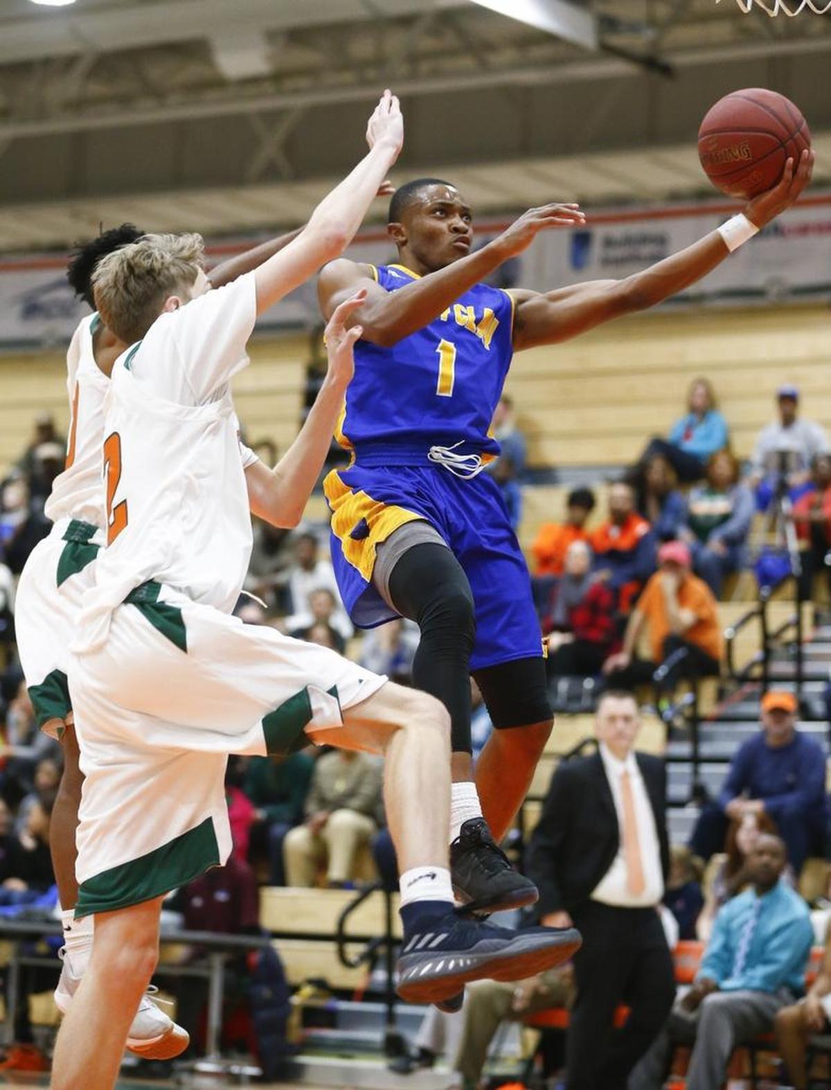 Henry Clay's Jalen Williams (1) goes to the basket past Frederick Douglass' Julius Scearce (30) and Frederick Douglass' Brendan Reynolds (12) during their game at Frederick Douglass High School in Lexington, Ky., Tuesday, Nov. 28, 2017.