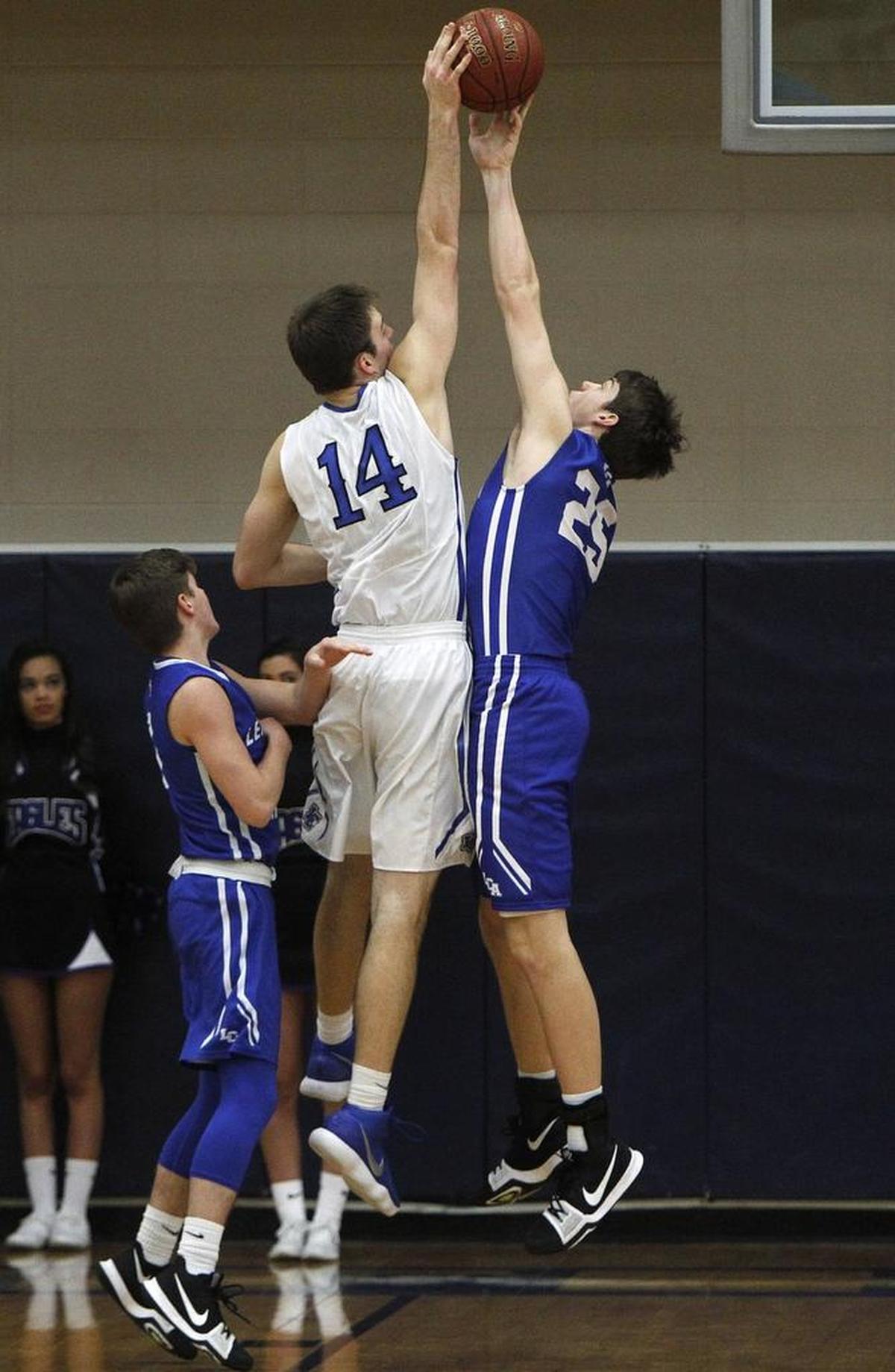 Lexington Christian Academy's Austin Hall blocks the shot by Lexington Catholic's Max Sparkman in the Bueter Gymnasium at Lexington Catholic in Lexington, Ky., Tuesday, January 2, 2018.