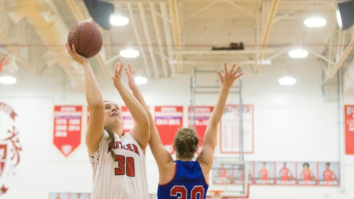 Butler Bearettes center Molly Lockhart (30) shoots the ball under pressure from Mercer County Titans forward Emma Souder (30) during the Girls Basketball game between Mercer County and Butler at Butler high school in Louisville, Ky.