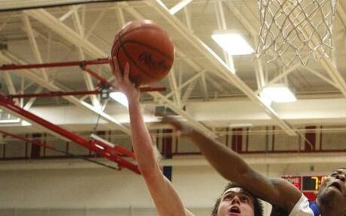 LexCath's Luke Johnson draws the and one foul against Lafayette's Jaelin Jenkins in the semifinals of the 43rd district basketball tournament at Lafayette's Jackson Carlisle Gymnasium in Lexington, Ky., Tuesday, February 22, 2016.
