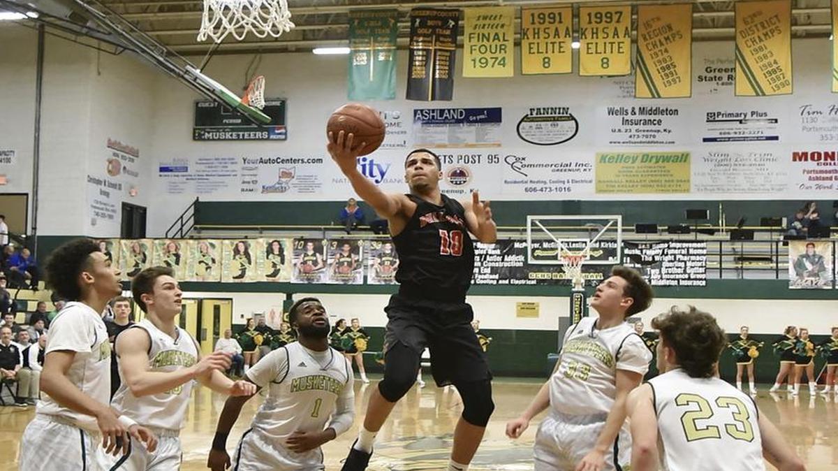 Lawrence County's Tim Dalton (10) shoots between the Greenup County defense Monday, Feb. 6, 2017 in Lloyd, Ky.