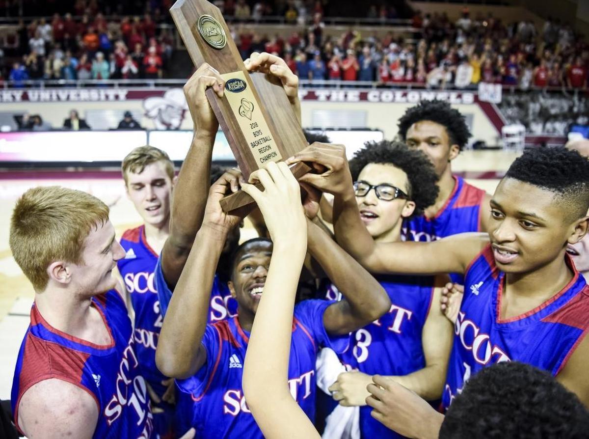 Scott County’s Cam Fluker, center, held up the 11th Region championship trophy with his teammates after their defeat of Lexington Christian.