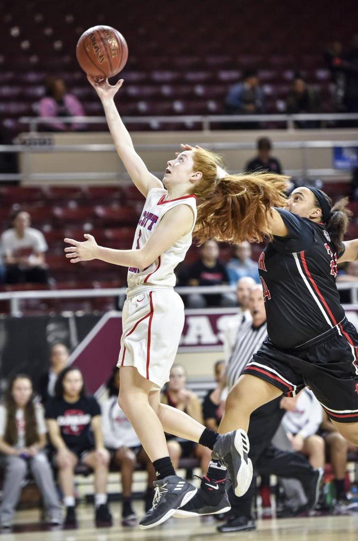 Scott County's Morgan DeFoor (1) shoots past Dunbar's Anaiyah Cotton (24), during the semi finals of the 11th Region tournament, Friday night, March 2, 2018, at EKU's McBrayer Arena in Richmond.