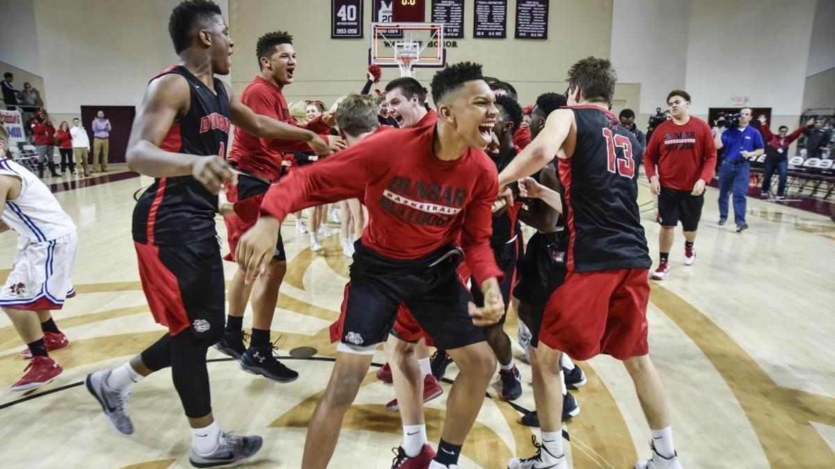 Paul Laurence Dunbar’s players celebrated after defeating Scott County 51-39 in the 11th Region finals at EKU’s McBrayer Arena in Richmond.