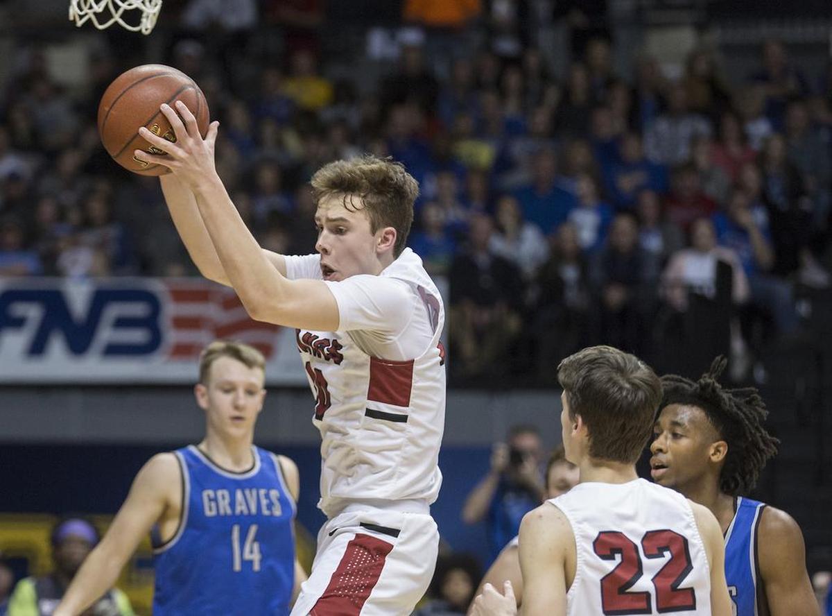 McCracken County’s Jackson Sivills grabs a rebound during the 1st Region Tournament championship game against Graves County at the CFSB Center in Murray, Ky., March 6, 2018.