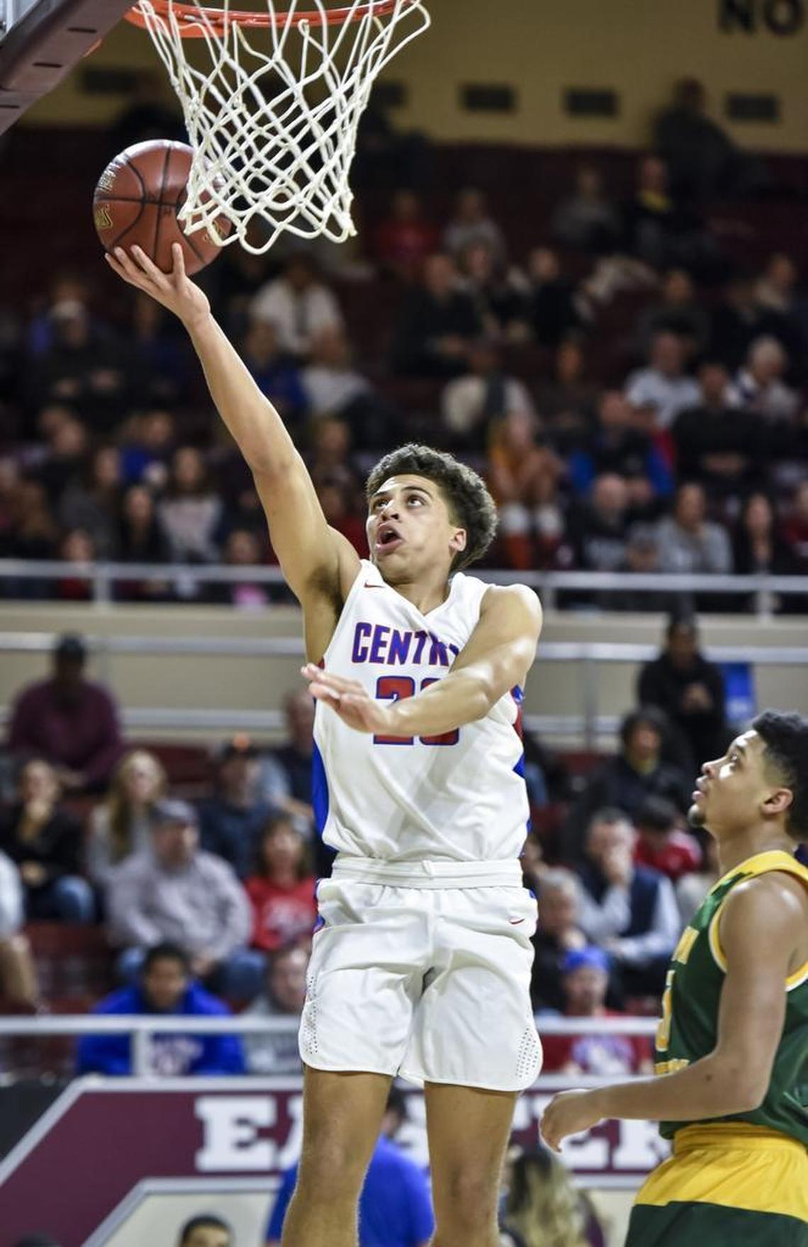 Madison Central's Dustin Gerald (23) shoots around Bryan Station's Jalen Burbage (3), during the first round of the 11th Region tournament, Wednesday night, February 28, 2018, at EKU's McBrayer Arena in Richmond.