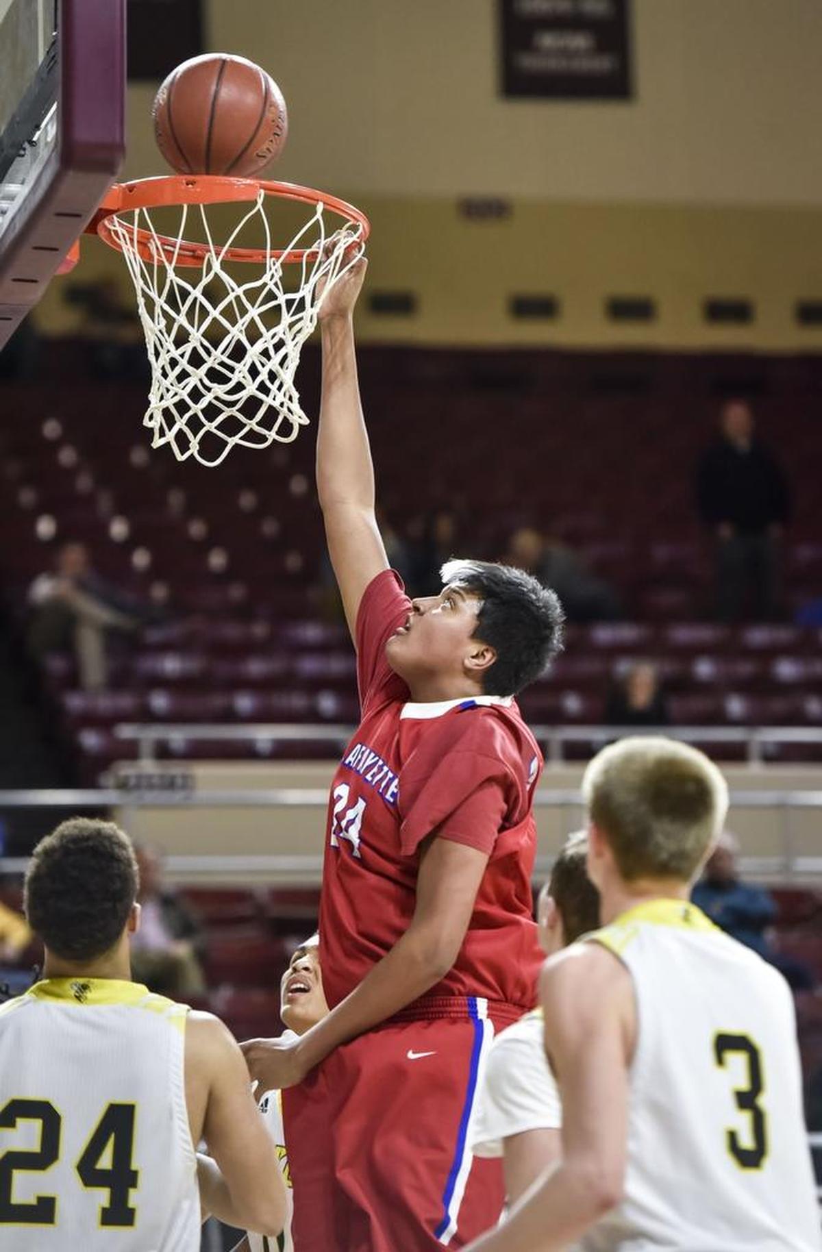 Lafayette’s Ray Surratt (34) dunked the ball over Woodford County’s Corey George (24), during the first round of the 11th Region tournament, March 1, 2018, at EKU’s McBrayer Arena in Richmond.