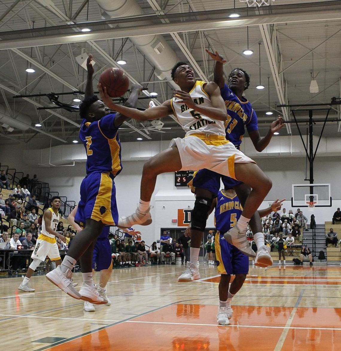 Bryan Station's Eric Boone shot Wednesday evening against Henry Clay's Terron Hughes, left, and Andreus Green during the boys' 42nd district tournament at Lexington Christian.