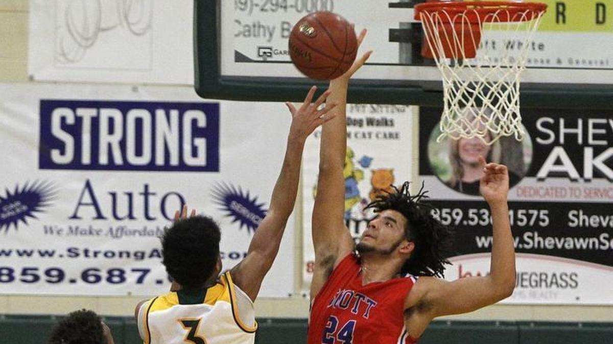Scott County's Michael Moreno blocks the shot by Bryan Station's Jalen Burbage at Bryan Station gym in Lexington, Ky., Monday, January 22, 2018.