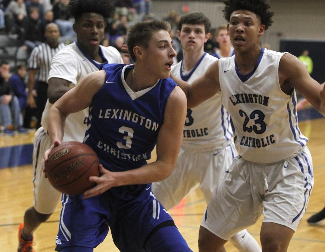 Lexington Christian Academy's Carter Hendrickson moves to the basket against Lexington Catholic's Zan Payne in the Bueter Gymnasium at Lexington Catholic in Lexington, Ky., Tuesday, January 2, 2018.