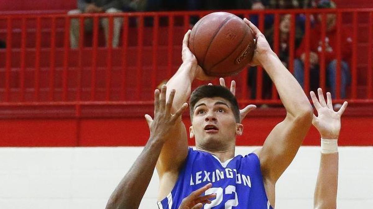 Lexington Christian's Kyle Rode (22) shoots past Scott County's Glenn Covington (14) and Scott County's Bryce Long (2) during their game at Scott County High School in Georgetown, Ky., Thursday, Dec. 7, 2017. Scott County beat Lexington Christian 68-59.