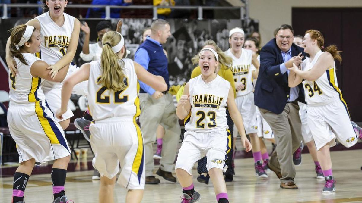Franklin County's Emily Jordan (23) runs onto the court to celebrate with her teammates after beating Henry Clay 58-56 in the 11th Region final, Sunday afternoon, March 8, 2015, at McBrayer Arena in Richmond.