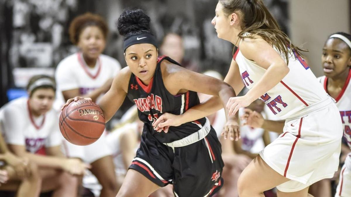 Paul Laurence Dunbar's Mashayla Cecil (23) drives past Scott County's Peyton Riddle (22), during the semi finals of the 11th Region tournament, Friday night, March 2, 2018, at EKU's McBrayer Arena in Richmond.