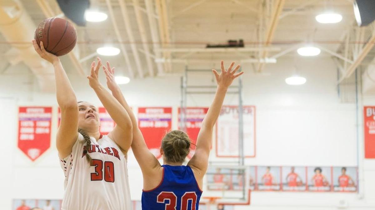 Butler Bearettes center Molly Lockhart (30) shoots the ball under pressure from Mercer County Titans forward Emma Souder (30) during the Girls Basketball game between Mercer County and Butler at Butler high school in Louisville.