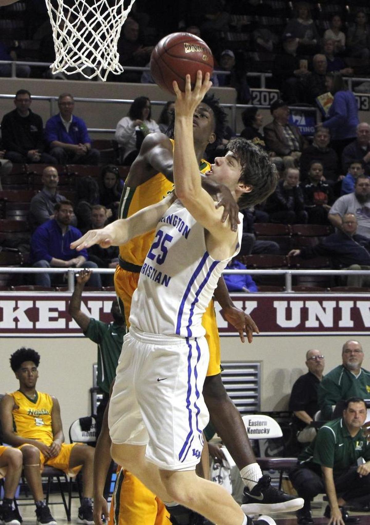 Lexington Christian’s Austin Hall draws the and one foul as he shoots against University Heights in the first round of the All 'A' Classic at Alumni Coliseum in Richmond, Ky., Thursday, January 25, 2018.