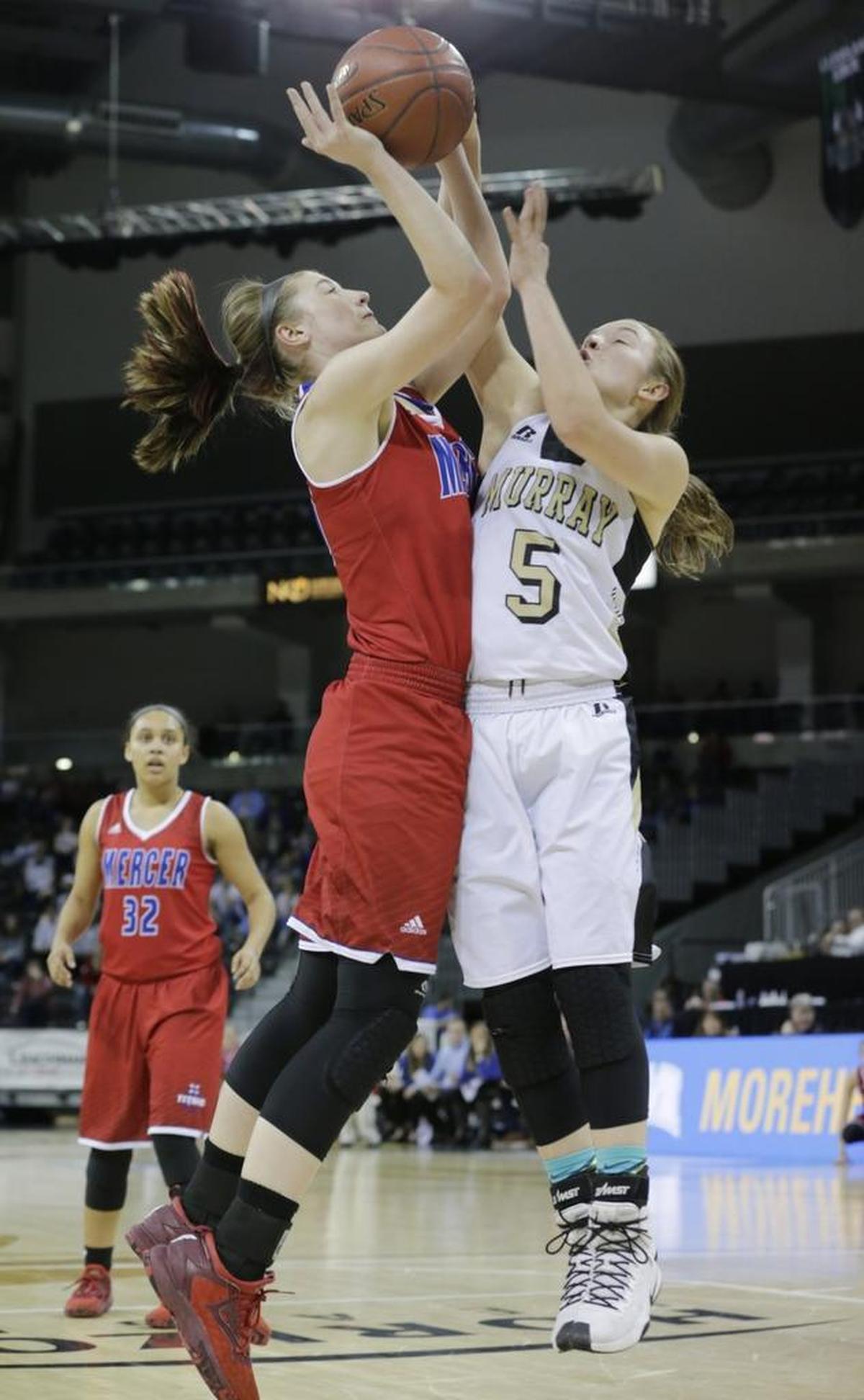 Mercer County Emma Souder (30) was fouled by Murray's Macey Turley in the second quarter of the the Murray vs Mercer Co. Girl's Sweet 16 semifinal basketball game at BB&T Arena in Highland Heights, Ky, on March 11, 2017.