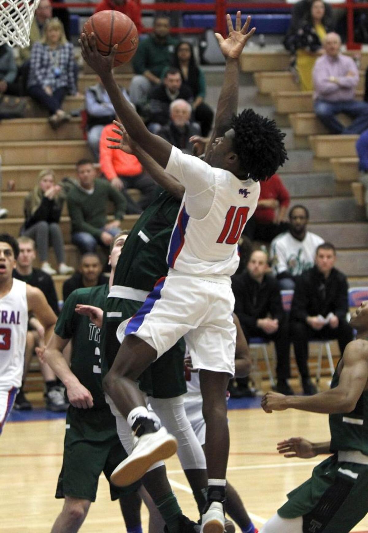 Madison Central's Jacori Miller shoots against Trinity at Madison Central gymnasium in Richmond, Ky., Friday, Jan. 26, 2018.