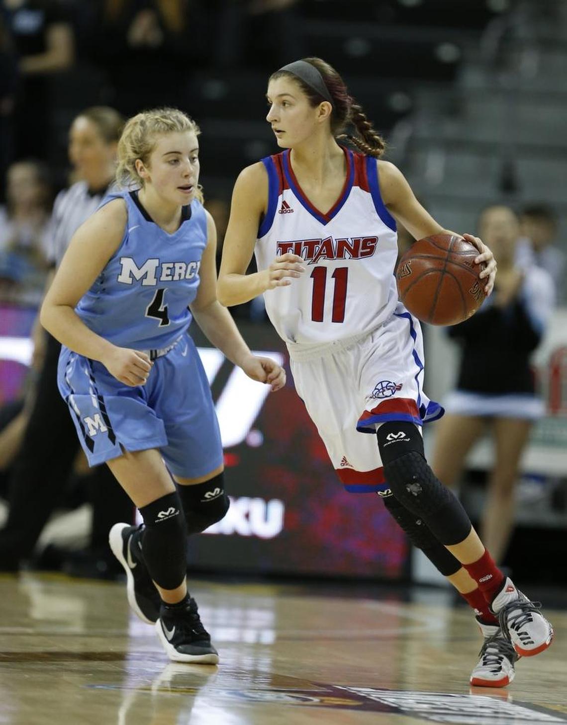 Mercer County’s Faith Lake (11) drove around Mercy’s Hope Sivori during the state championship game Sunday.