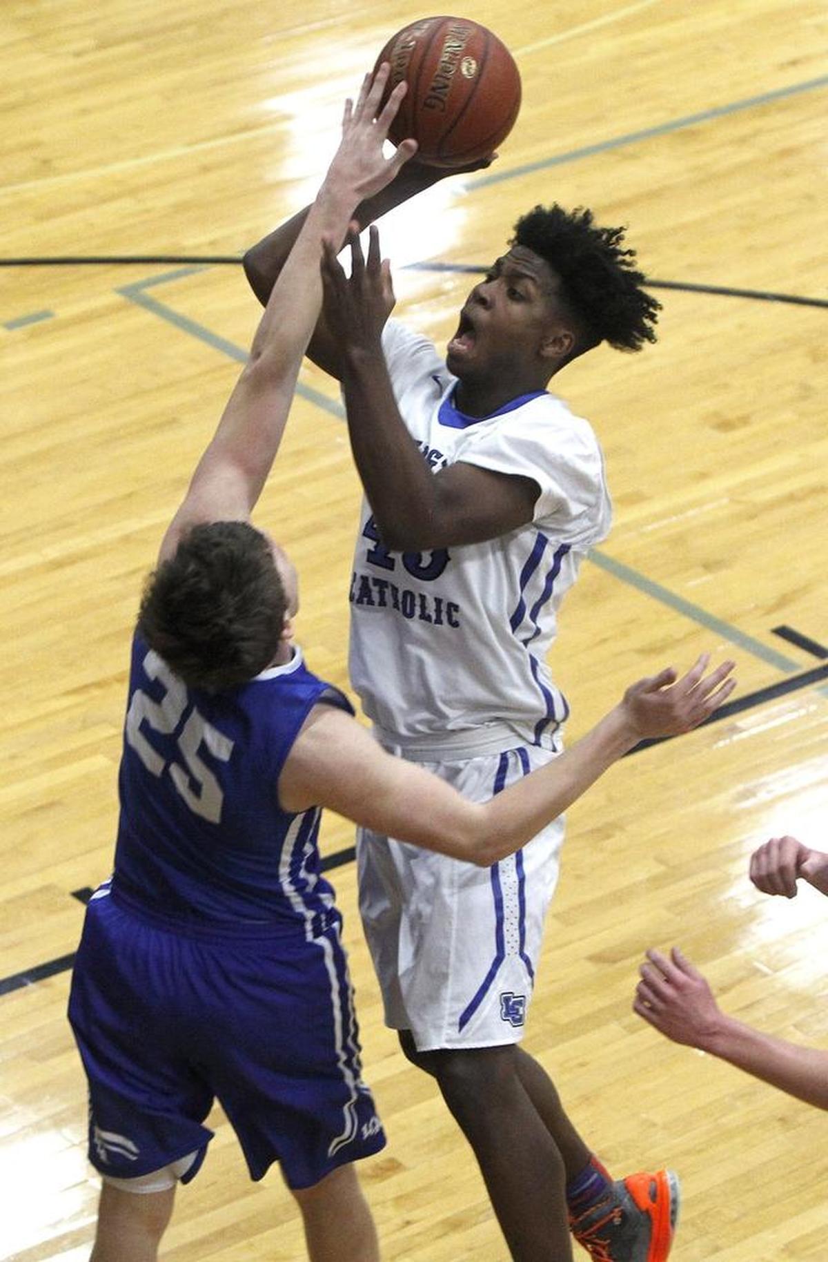 Lexington Catholic's Brice Scott shoots against Lexington Christian's Austin Hall in the Bueter Gymnasium at Lexington Catholic in Lexington, Ky., Tuesday, January 2, 2018.