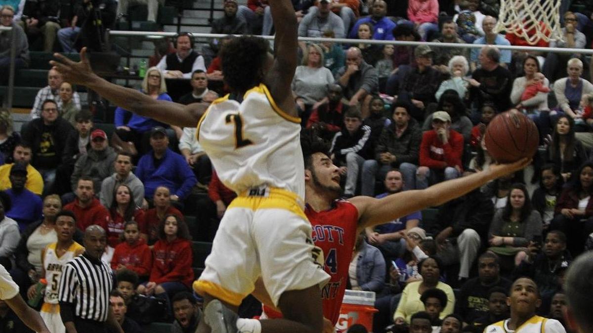 Scott County’s Michael Moreno took a shot as Bryan Stations Kendrick Curry sailed in to attempt a block on Jan. 22.