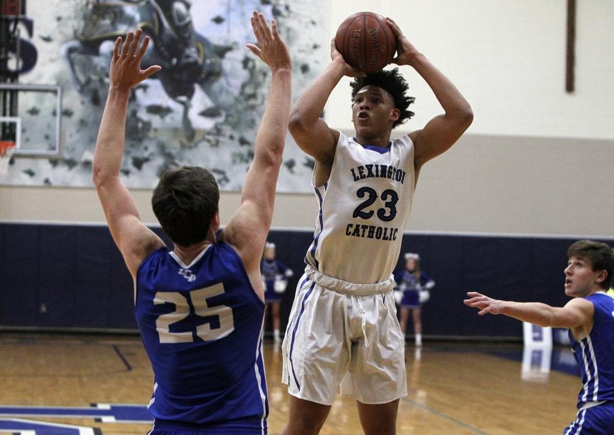 Lexington Catholic's Zan Payne shoots against Lexington Christian's Austin Hall in the Bueter Gymnasium at Lexington Catholic in Lexington, Ky., Tuesday, January 2, 2018.