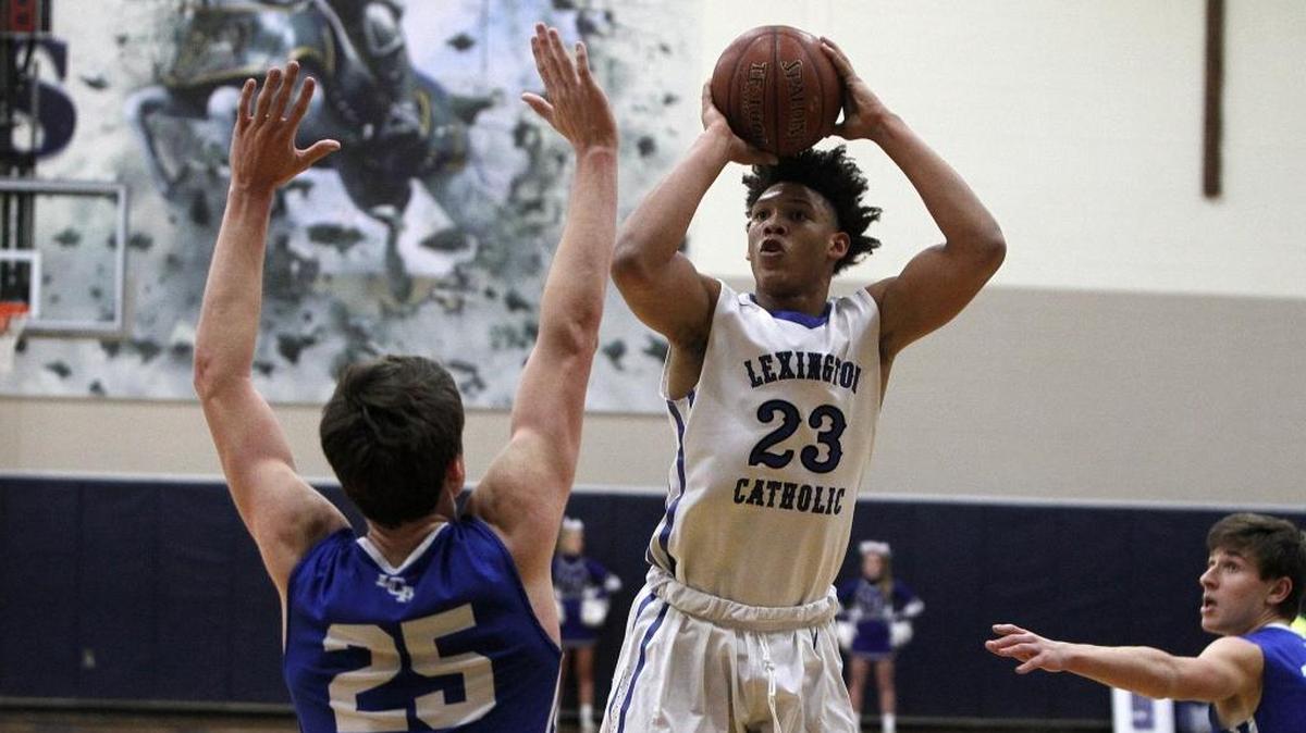 Lexington Catholic's Zan Payne shoots against Lexington Christian's Austin Hall in the Bueter Gymnasium at Lexington Catholic in Lexington, Ky., Tuesday, January 2, 2018.