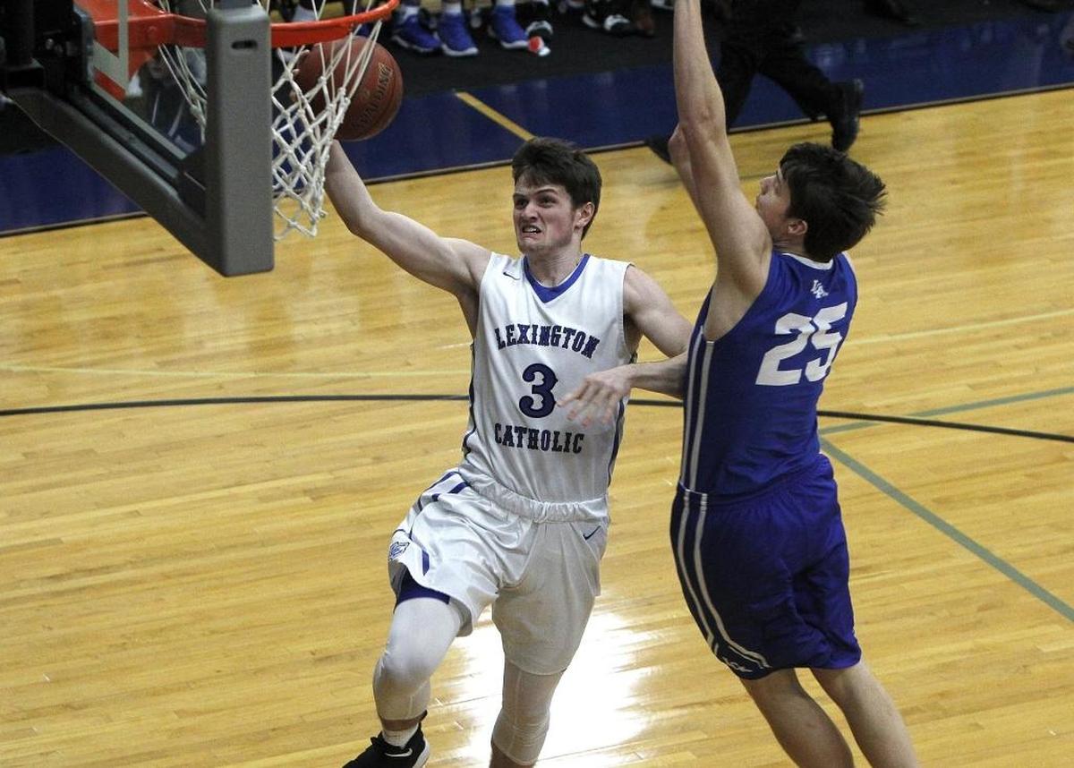 Lexington Catholic's T. C. Price shoots against Lexington Christian's Austin Hall in the Bueter Gymnasium at Lexington Catholic in Lexington, Ky., Tuesday, January 2, 2018.