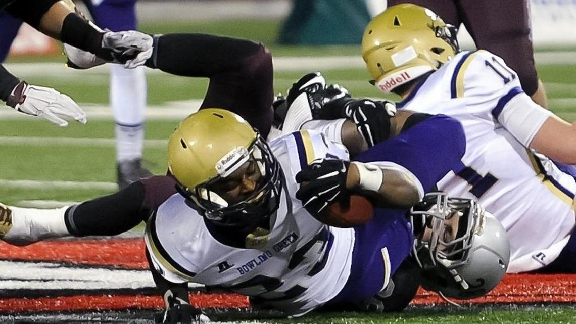 FILE PHOTO: Bowling Green's Jamale Carothers (23) gains some yards Saturday, Dec. 5, 2015, before getting tackled by Pulaski County's Jacob New (28) during the Class 5A Russell Athletic/KHSAA Commonwealth Gridiron Bowl championship at Houchens Industries-L.T. Smith Stadium in Bowling Green, Ky.