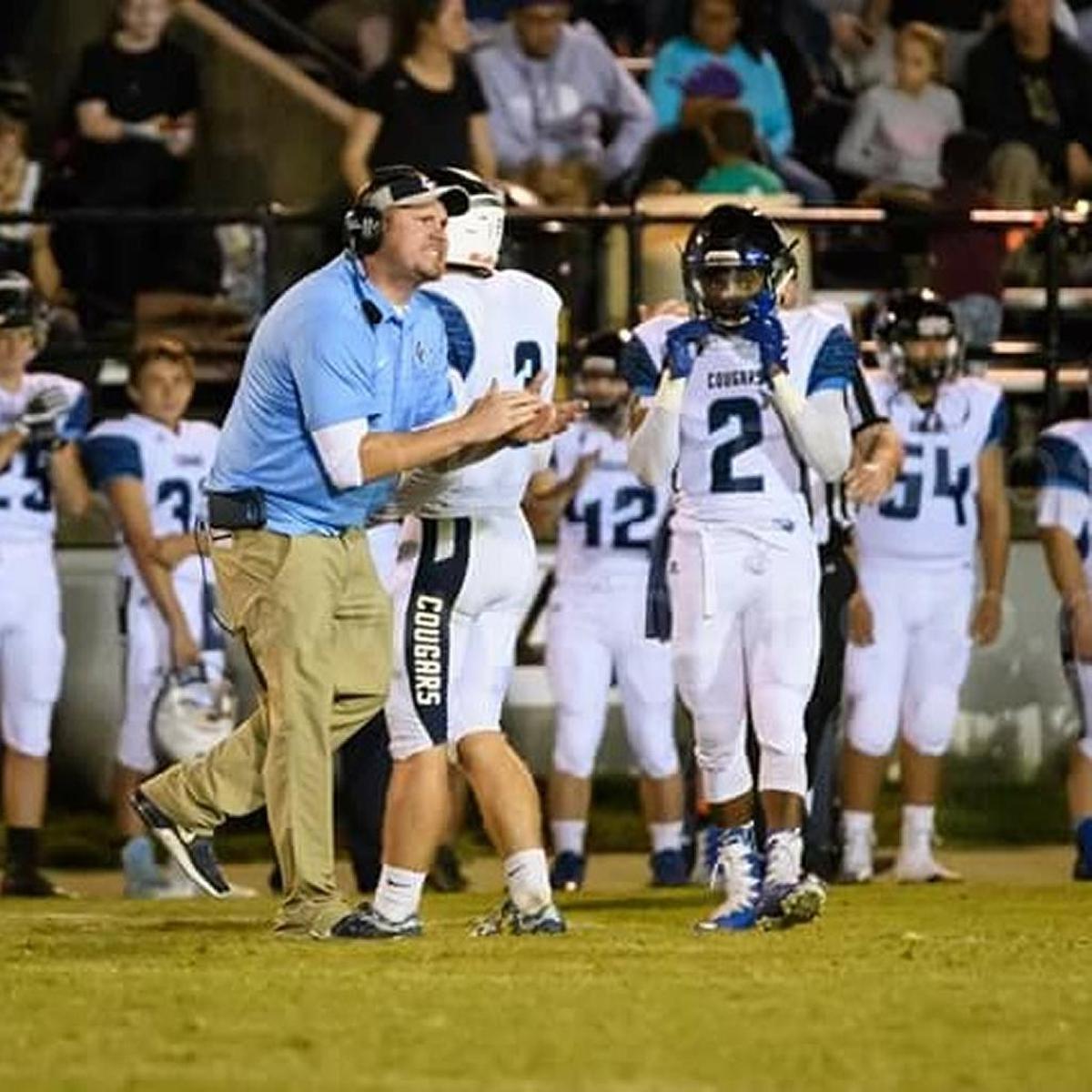 Logan County Coach Todd Adler, left, is in his second season with a program that had lost 33 straight games when he took the job. The streak grew to 42 games before the Cougars snapped it in the final game of the 2016 regular season. They haven’t lost since.